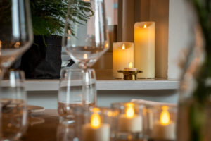 sfeerfoto kaarsen met afstandsbediening op tafel met wijnglazen